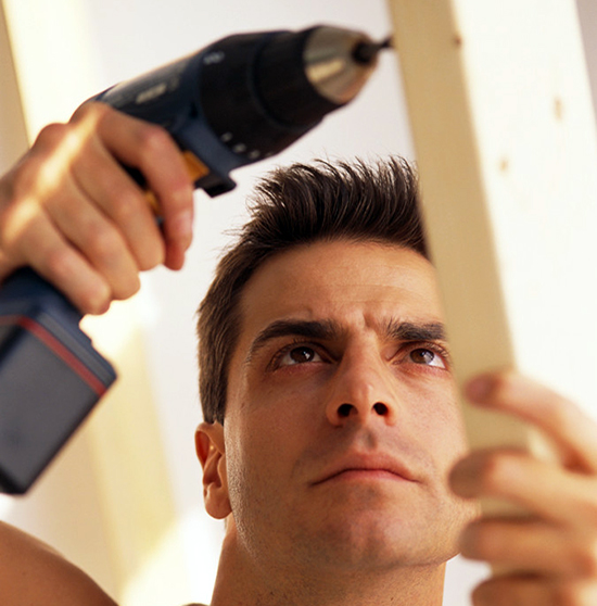 Man Using Electric Drill